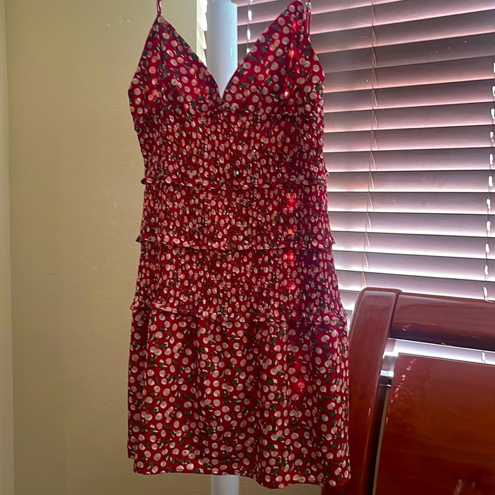 Large, short red dress with beige cherries and green leaves